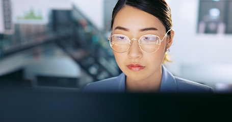 Image showing Face, glasses and management with a business asian woman at work on a computer in her office. Data, reading and email with a young female employee working on a report using a desktop for research