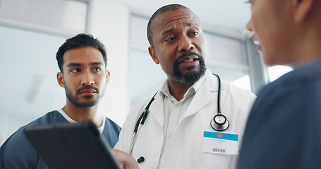 Image showing Tablet, nurses and doctor talking in hospital, discussing research or medical records. Wellness, digital tech and group of physicians, men and women chatting about online healthcare results in clinic