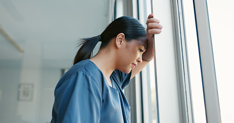 Image showing Mental health, stress and depressed doctor at window in China, burnout and headache from late surgery. Anxiety, depression and woman in medical field or healthcare professional overworked and tired.