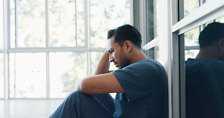 Image showing Nurse, stress or depression man on hospital floor in virus death, surgery fail or patient loss grief in Japanese clinic. Mental health, sad or anxiety for crying healthcare worker in medical burnout