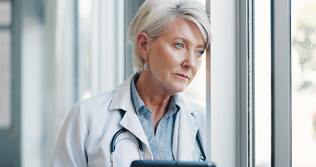 Image showing Stress, woman or doctor thinking at window with burnout in hospital office after surgery. Medicine, anxiety and mental health, senior medical professional in Canada tired from overtime or depression.