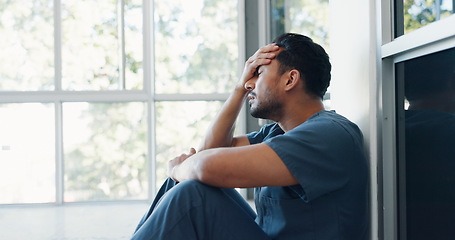 Image showing Nurse, stress or depression man on hospital floor in virus death, surgery fail or patient loss grief in Japanese clinic. Mental health, sad or anxiety for crying healthcare worker in medical burnout