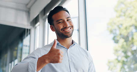 Image showing Businessman, thumbs up and wink while walking in office for success, motivation or thank you. Face portrait, yes and male employee from Singapore with hand gesture for support, like emoji or approval