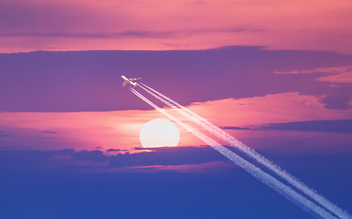 Image showing Passenger plane passes near the sun