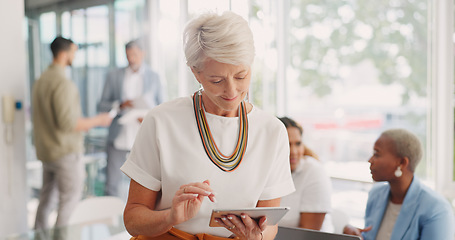 Image showing Business woman, senior and digital tablet for leader planning, thinking and research while in business meeting. Mature woman, internet and search while leading a meeting with creative group in office