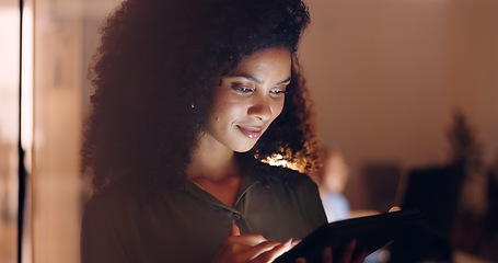 Image showing Office, night and happy black woman on a phone at her job in the dark smiling about funny text. Business, technology and social media mobile app scroll of a person working late on a work break