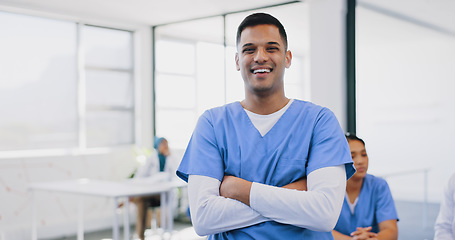 Image showing Face, healthcare and insurance with a nurse man standing arms crossed in a hospital for medical treatment. Portrait, doctor and trust with a male medicine professional in a clinic for diagnosis