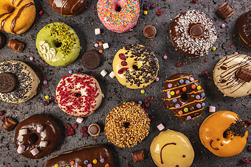 Image showing Various glazed doughnuts with sprinkles.