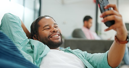 Image showing Black man, phone and peace sign on video call with smile for social, networking or communication at the office. African American man relaxing on break talking on smartphone videocall at the workplace