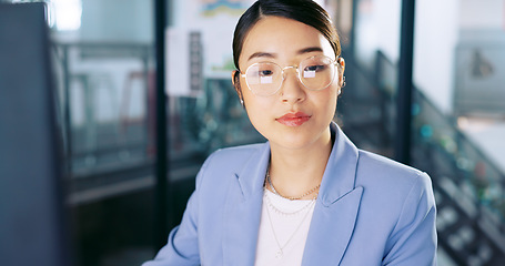 Image showing Computer, office and Asian business woman with glasses typing and planning a corporate project. Success, professional and professional employee working on a company report, document or proposal on pc