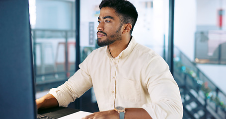 Image showing Computer, research and businessman working on a project, report or document in his modern office. Technology, professional and Indian male employee typing company proposal with deadline in workplace.