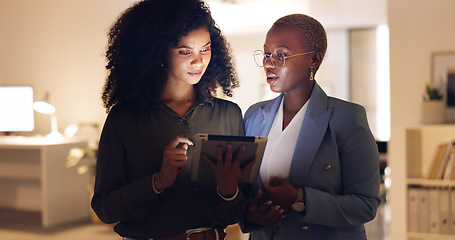 Image showing Black woman, employees working in office at night and discuss a corporate plan with digital tablet . Company marketing team, talking business strategy and collaborating for professional brand success