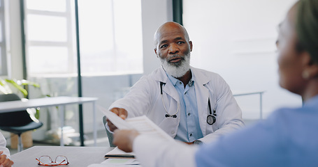 Image showing Meeting, healthcare and collaboration with a doctor black man and his medicine team in discussion over documents at the hospital. Nurse, teamwork and partnership with professional medical group