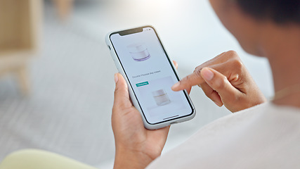 Image showing Shopping online and scrolling through makeup products to find a sale or discount. Hands of a woman browsing cosmetics on her phone from above. Enjoying the convenience and ease of purchasing apps