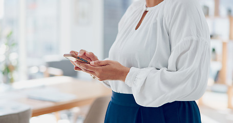 Image showing Business, woman and phone typing in office while reading funny notification, online news or text message, social networking and connection. Mature female manager, mobile app and smartphone technology