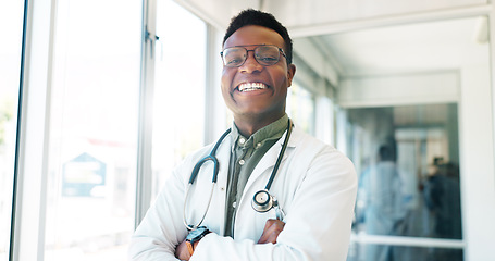 Image showing Portrait, healthcare and trust with a black man doctor standing arms crossed in a hospital hallway. Health, medical and insurance with a male medicine professional working in a clinic for treatment