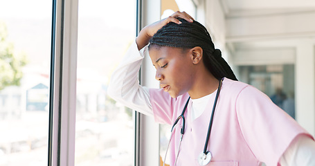 Image showing Nurse, stress thinking and hospital window for relax breathing, stress relief and healthcare worker frustrated or overworked. Black woman, employee burnout and anxiety headache working in clinic