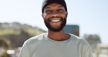 Image showing Happy black man standing outdoor in the city with a smile on his face. Portrait, freedom and carefree with a young male gesturing or signing in a town