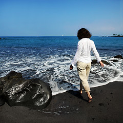 Image showing Woman on black sand beach 