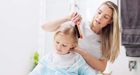 Image showing Morning, mother and daughter in bathroom with hair brush for grooming care routine in family home. Motherhood, child and mama brushing hair of young kid in house and getting ready for the day.