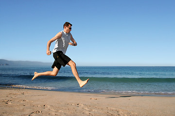 Image showing man running on the beach