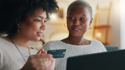 Image showing Payment, credit card and friends online shopping on a laptop for discount or sale on a digital fintech website at home. Ecommerce, happy and excited African women on the sofa banking on the internet