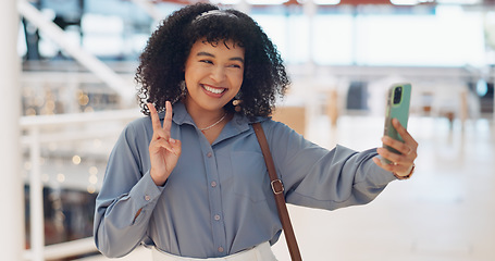 Image showing Black woman influencer, selfie and peace sign with smile, smartphone or walking in urban shopping mall. Happy, phone and woman with hand gesture for social media, web or online app at mall in Atlanta