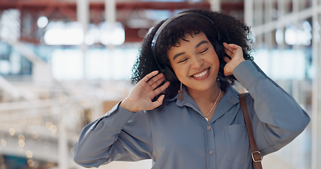 Image showing Music, headphones and black woman in mall for freedom, relax and calm energy, dance, listening and happy with her travel journey. Urban building, gen z and audio technology for inspiration in retail