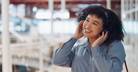 Image showing Music, headphones and black woman in mall for freedom, relax and calm energy, dance, listening and happy with her travel journey. Urban building, gen z and audio technology for inspiration in retail