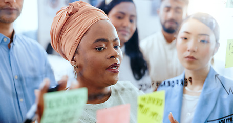 Image showing Meeting, project management and business people with sticky note planning, training and schedule strategy. Solution, coaching and black woman talking to employees about idea, company goal and vision