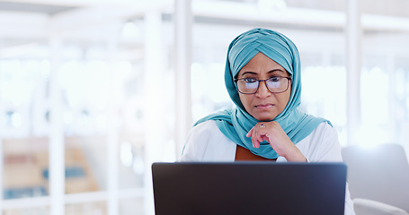 Image showing Muslim business woman, focus and working at laptop, email and communication with focus and technology. Worker in hijab, corporate goals with internet, networking and research online for project