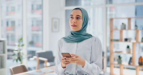 Image showing Phone, thinking and feedback with a business muslim woman typing a text message in her office at work. Contact, mobile and idea with an islamic female employee reading an email while working alone