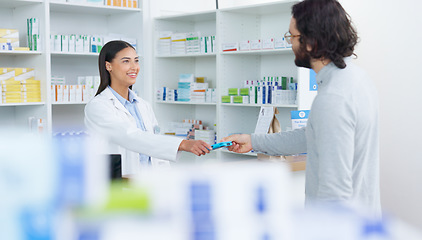 Image showing Patient buying medicine from pharmacist at the pharmacy store. Customer receives prescription medication at the chemist store from medical doctor. Healthcare professional accepts credit card payment