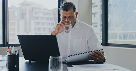 Image showing Businessman, office and drink water with documents, laptop and focus for market research, analysis or target. Advertising expert, paper or strategy with data analytics, kpi or goals for marketing job