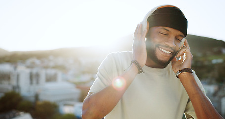 Image showing Dance, music and man on a rooftop at sunset, dancing and streaming while listening to radio. Podcast, freedom and black man on balcony, positive and enjoy audio track on headphones with city view