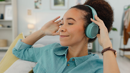 Image showing Relax, music and black woman with headphones on sofa for wellness rest and streaming with satisfied smile. Self care, happy and comfortable girl listening to musical audio app in home bedroom.