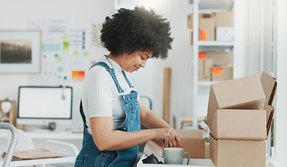 Image showing Startup, delivery and shipping in boxes for online shopping business. Businesswoman packing products from online business in a box to ship to clients and buyers. Black woman working in the office