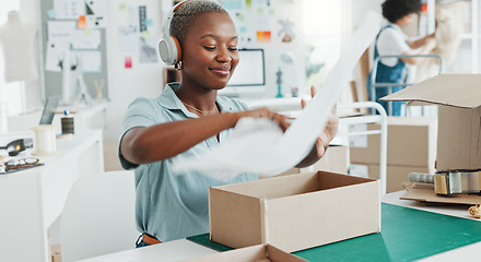 Image showing Startup, shop and entrepreneur packing a box for an order of products for shipment or delivery. Black business owner preparing a retail package for courier with her corporate partner in their office.