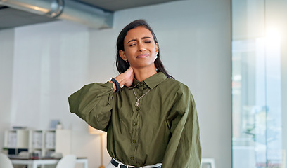 Image showing Businesswoman suffering from neck pain and discomfort caused by stress burnout and anxiety in a corporate office. Employee struggling with muscle spasm and stiff joints while looking unhappy at work