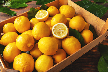 Image showing Fresh lemon with leaves in crate