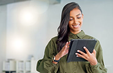 Image showing Business woman typing an email, browsing the internet and searching for ideas on a tablet at work. Female corporate professional, expert and designer scrolling on social media or reading a blog