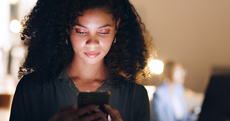 Image showing Social media, phone and black woman in a dark office for a corporate deadline at night. African worker, manager or employee typing on a mobile app with a smartphone while working overtime at work