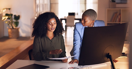 Image showing Documents, collaboration and talking with a business woman team working in their office at night. Teamwork, conversation and training with a female employee explaining a report to a colleague