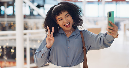 Image showing Black woman influencer, selfie and peace sign with smile, smartphone or walking in urban shopping mall. Happy, phone and woman with hand gesture for social media, web or online app at mall in Atlanta