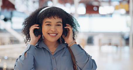 Image showing Music, headphones and black woman in mall for freedom, relax and calm energy, dance, listening and happy with her travel journey. Urban building, gen z and audio technology for inspiration in retail