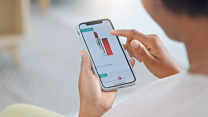 Image showing Shopping online and scrolling through makeup products to find a sale or discount. Hands of a woman browsing cosmetics on her phone from above. Enjoying the convenience and ease of purchasing apps