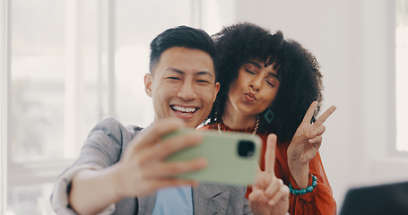 Image showing Phone, selfie and business people with peace in office for teamwork, collaboration and friendly workspace. Success, diversity and Asian man and black woman with smartphone, peace sign and smile