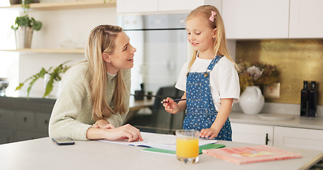 Image showing Education, mother and girl writing in kitchen for school task, assignment or homework. Help, learning and mom with child teaching, explaining or helping kid in home in the morning with books on table