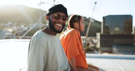 Image showing Black couple, smile and portrait on rooftop in city, outdoors and bonding. Diversity, sunglasses and happy man, woman and relax, love and having fun, enjoying view and spending quality time together.