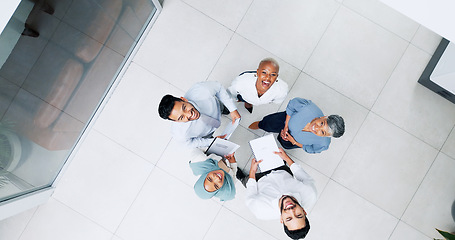 Image showing Top view, business and team in lobby, brainstorming and planning for marketing development, sales growth and office. Teamwork, innovation and staff share ideas, conversation and project collaboration